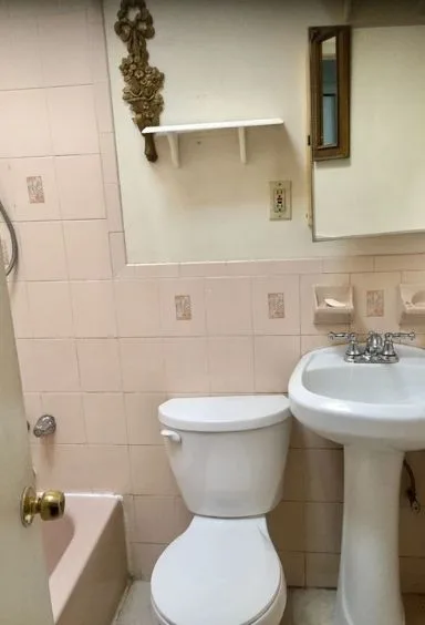Bathroom before the remodel, pink tile