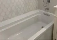 New bathtub with patterned wall tile